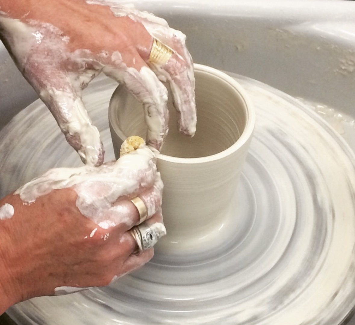 Pottery studio with students working on wheels